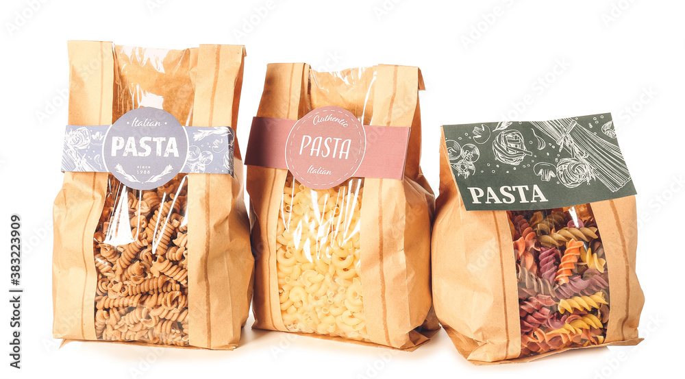 Bags with uncooked Italian pasta on white background