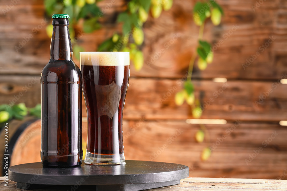 Glass and bottle of fresh beer on table