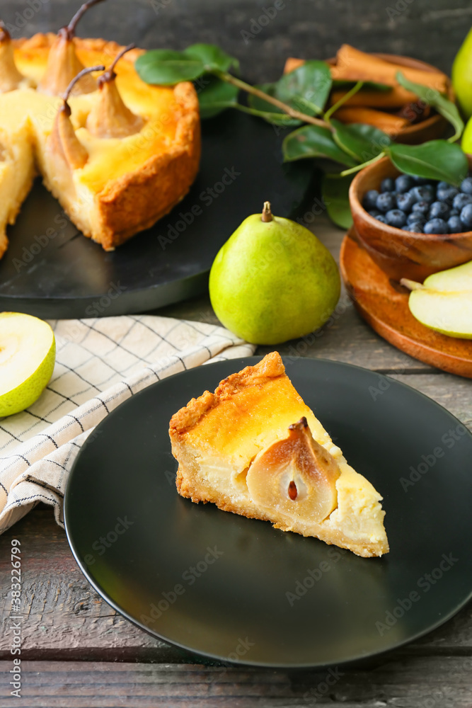 Plate with tasty pear cake on table