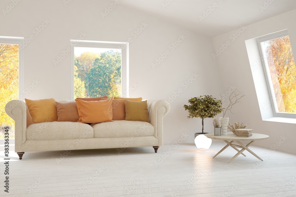 Stylish room in white color with sofa and autumn landscape in window. Scandinavian interior design. 