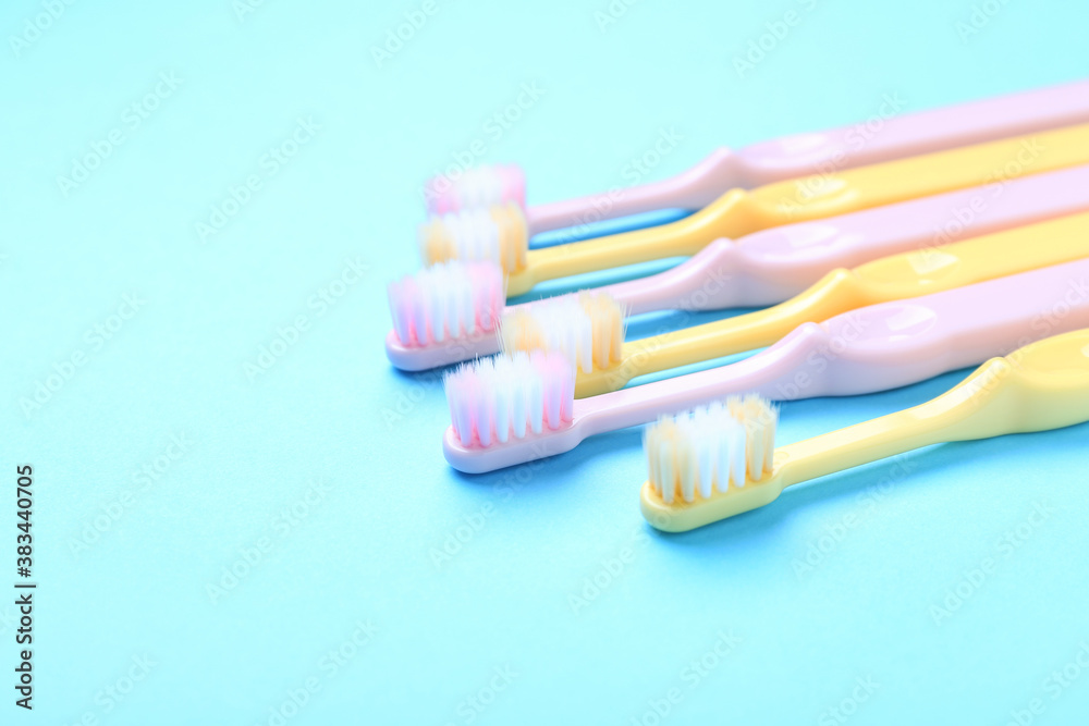 Tooth brushes on color background