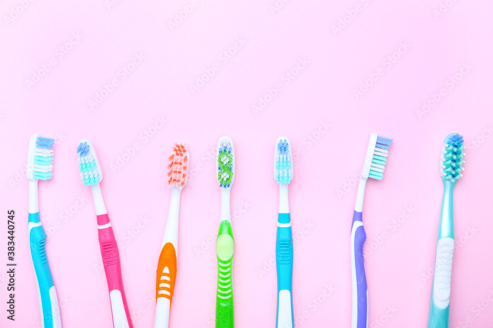 Tooth brushes on color background