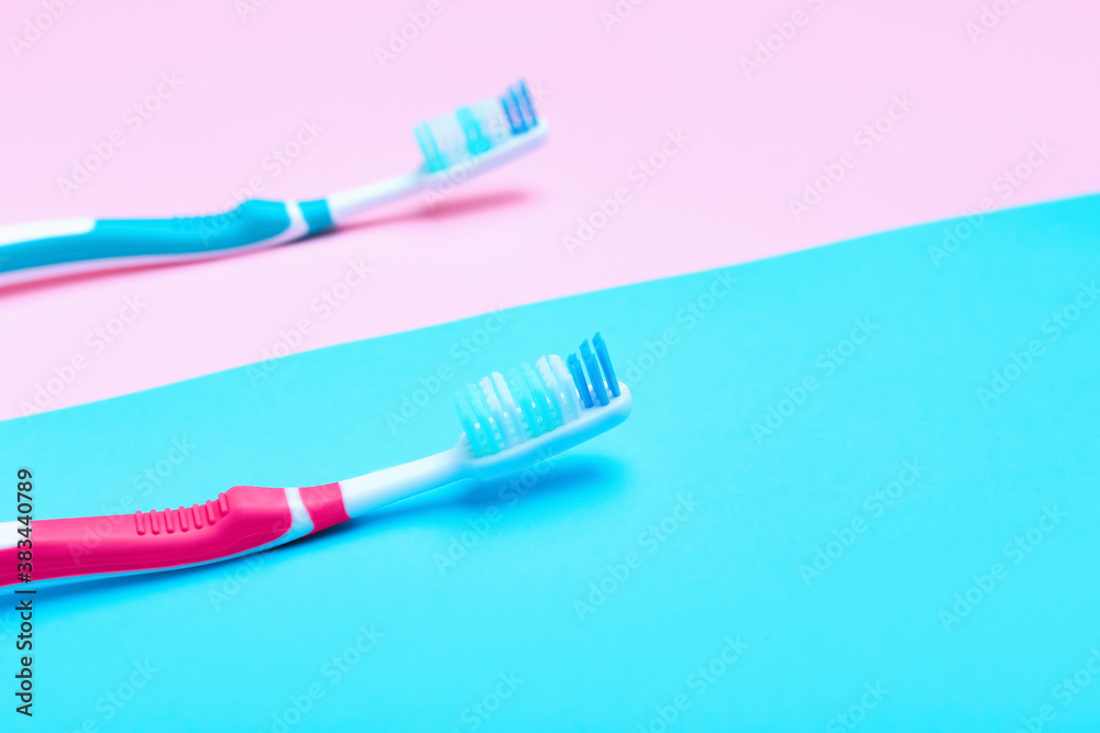 Tooth brushes on color background