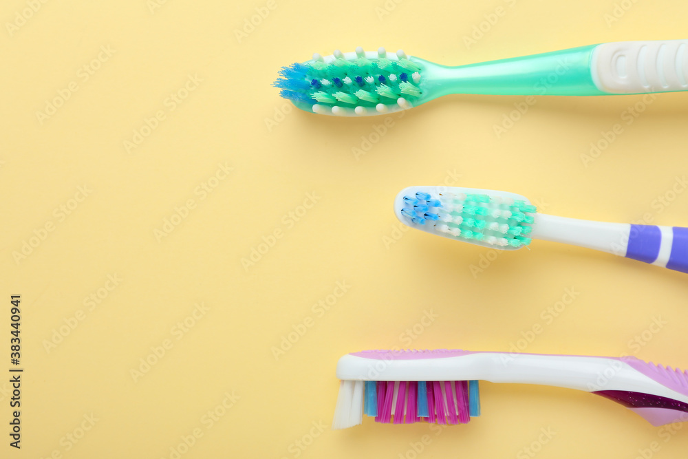 Tooth brushes on color background