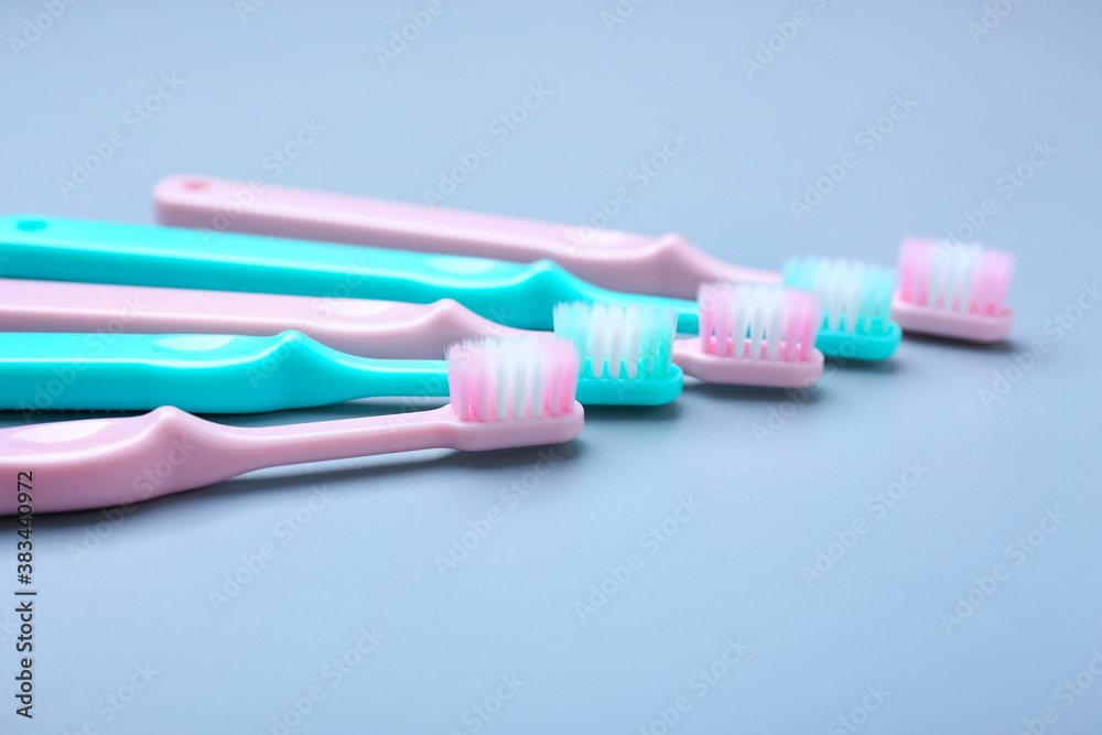 Tooth brushes on grey background