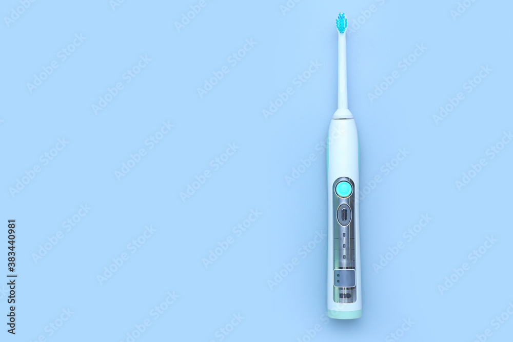 Electric tooth brush on grey background