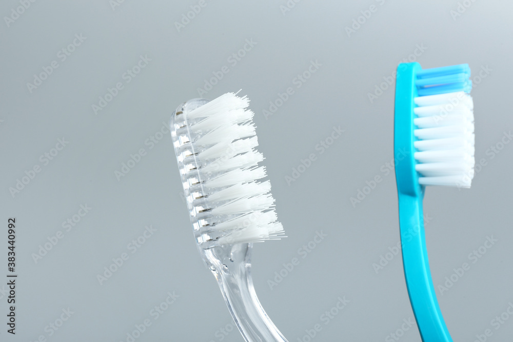 Tooth brushes on grey background