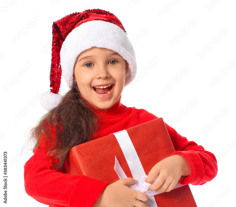 Cute little girl in Santa hat and with gift on white background