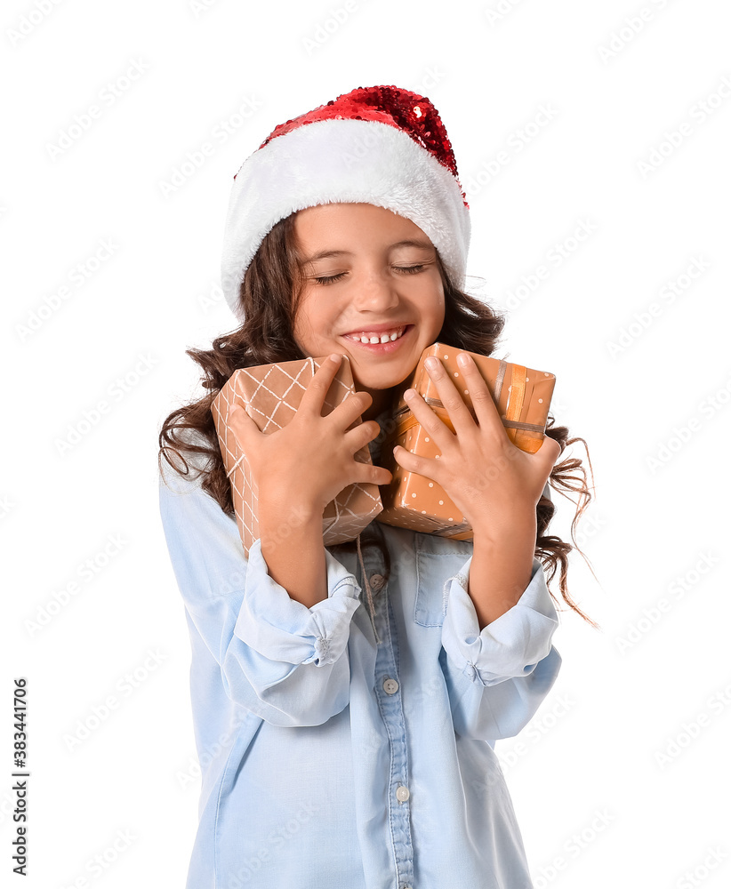 Cute little girl in Santa hat and with gift boxes on white background