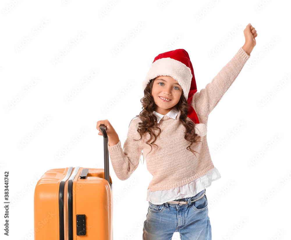 Cute little girl in Santa hat and with suitcase on white background. Christmas vacation concept