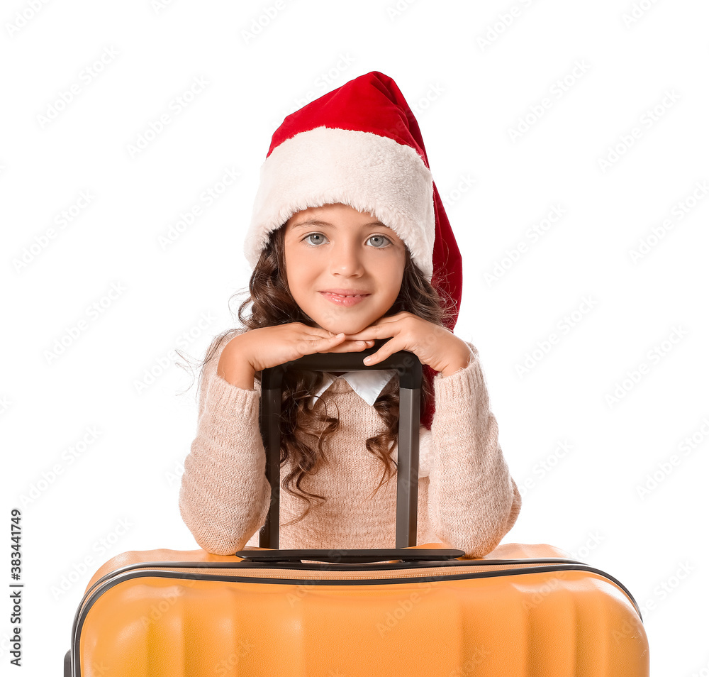 Cute little girl in Santa hat and with suitcase on white background. Christmas vacation concept