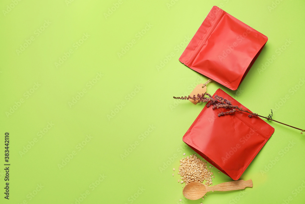 Bags with oat groat on color background