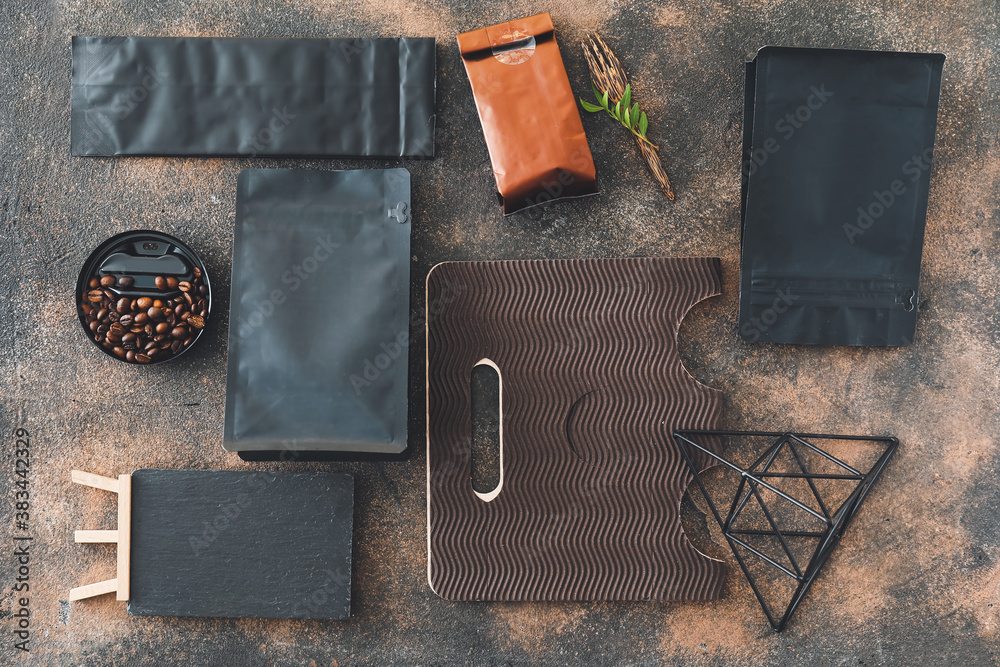 Blank bags with coffee beans on dark background