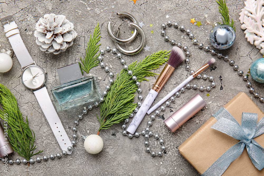 Christmas composition with cosmetics on grey background