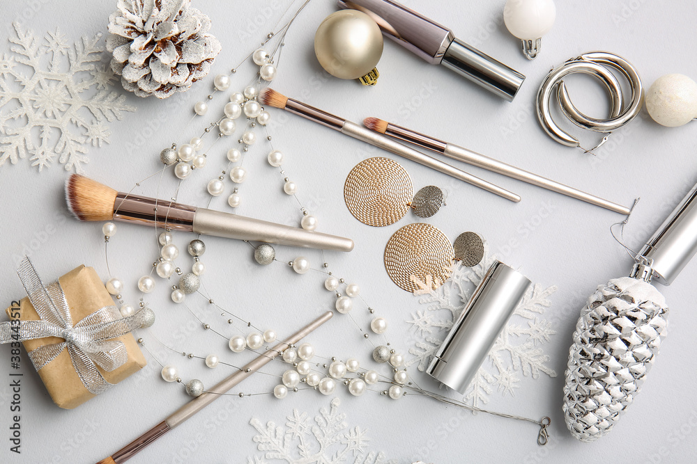 Christmas composition with cosmetics on light background