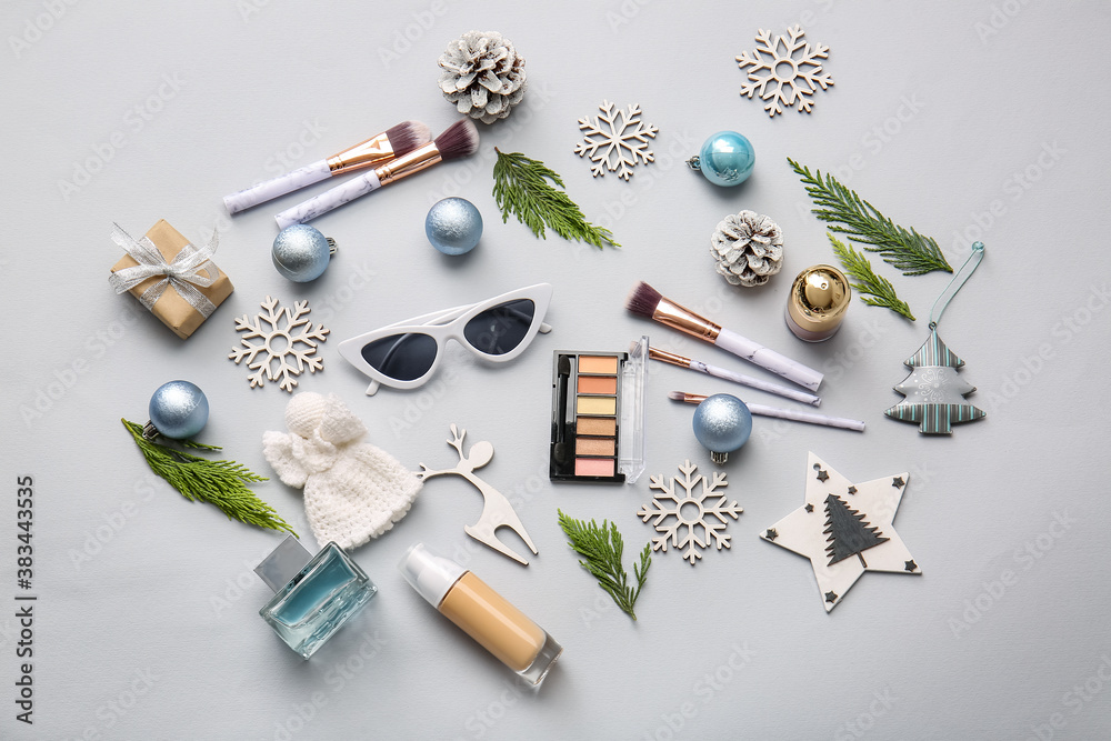 Christmas composition with cosmetics on light background