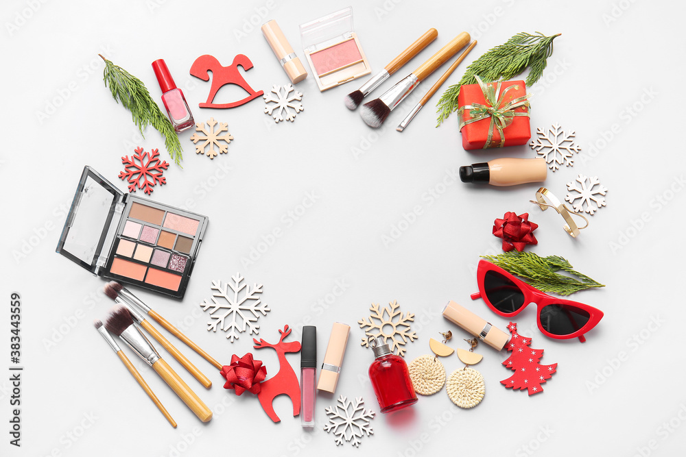 Christmas composition with cosmetics on light background