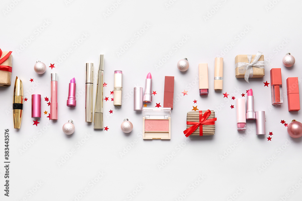 Christmas composition with cosmetics on light background