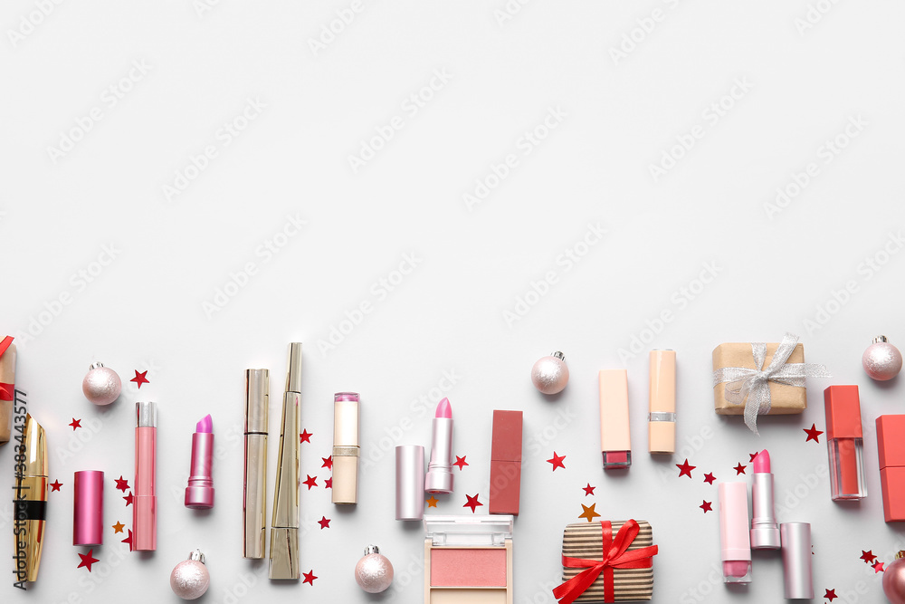 Christmas composition with cosmetics on light background