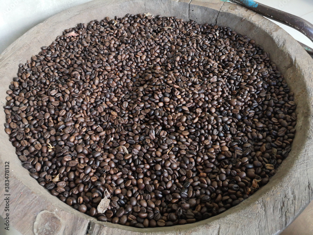 Roasted coffee beans in a wooden tray