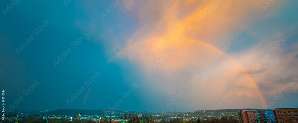 Sky panorama with rainbow after rain