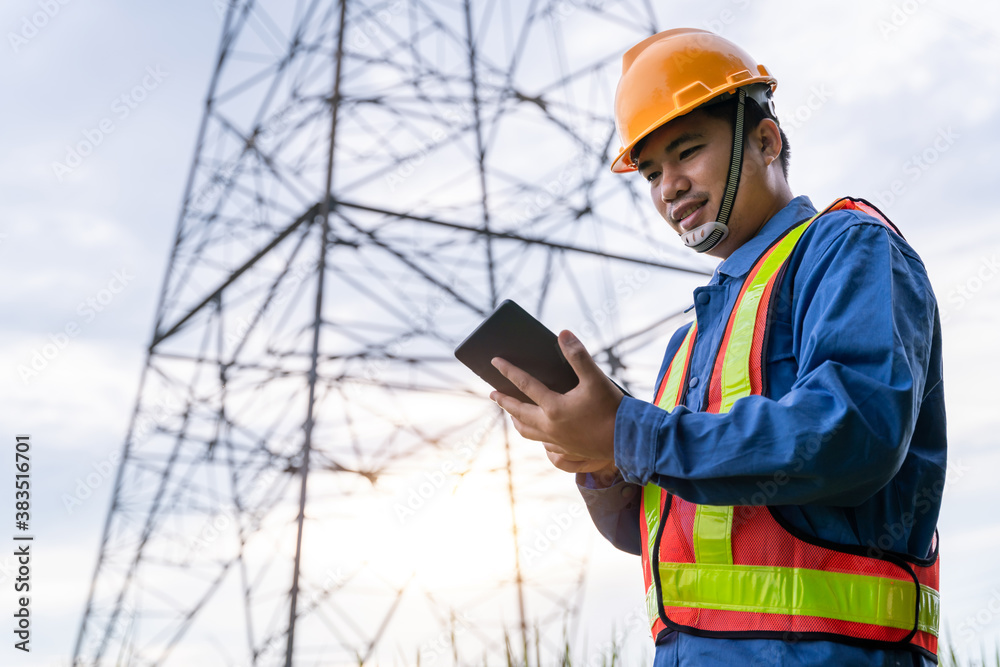 Asian electrical engineer wear safety clothes standing and watching at the electric power station to