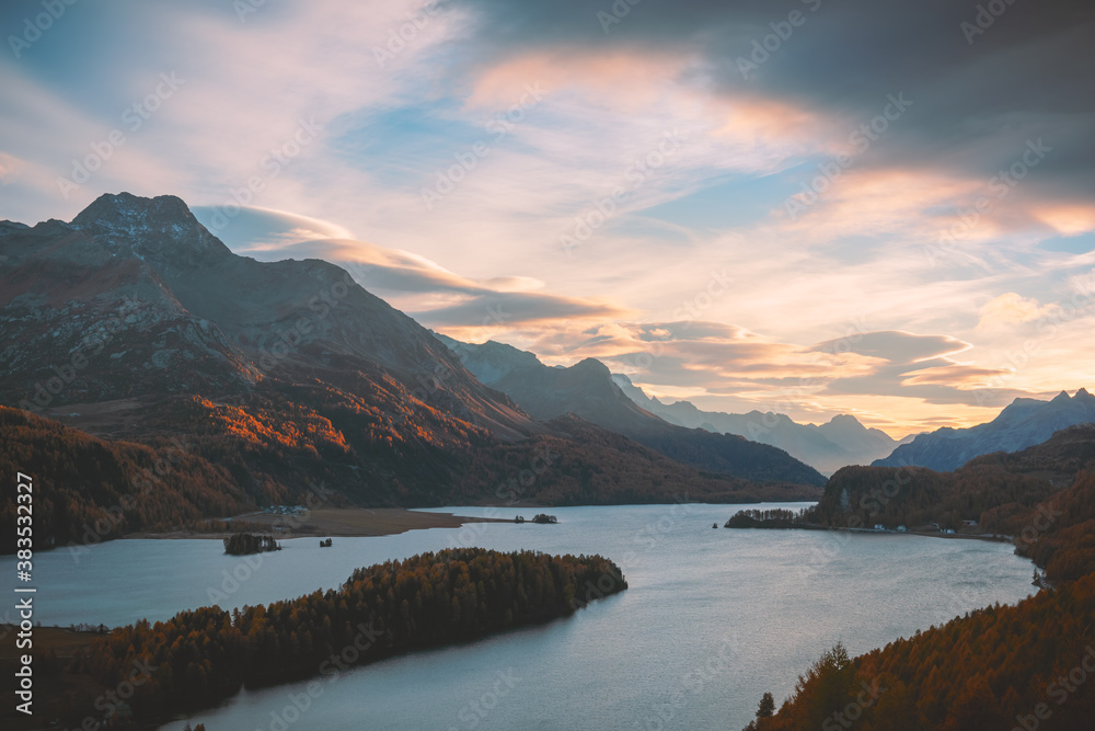 Aerial view on autumn lake Sils (Silsersee) in Swiss Alps mountains. Colorful forest with orange lar