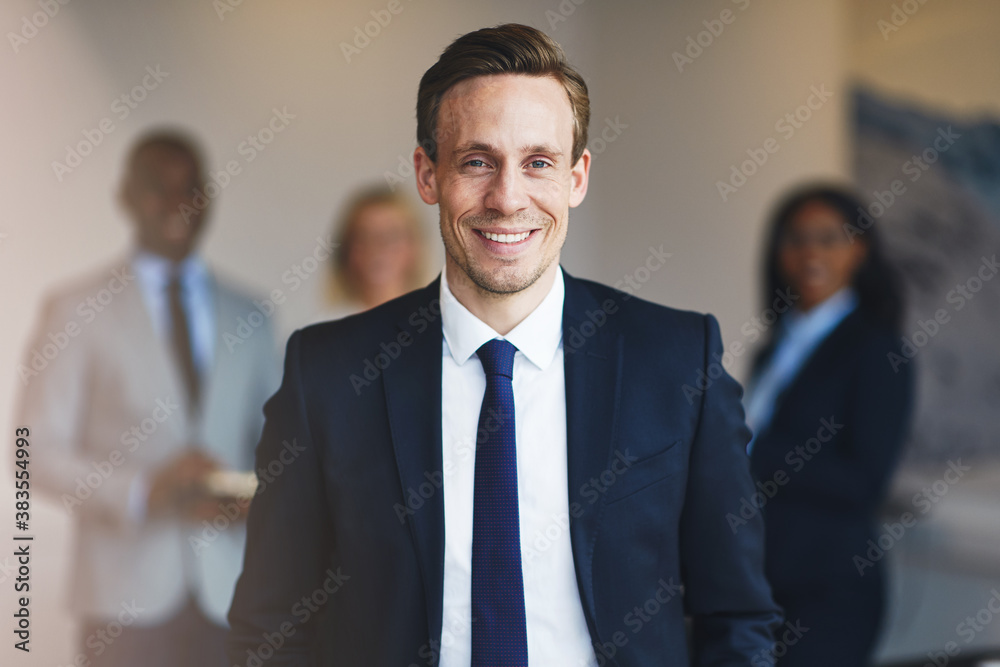 Businessman standing with coworkers in an office