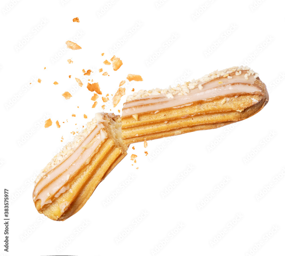 Delicious eclair broken into two halves in the air close-up on a white background