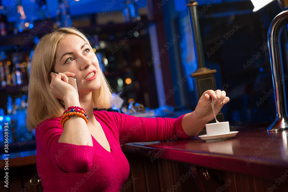 woman with a cup of coffee and cell phone