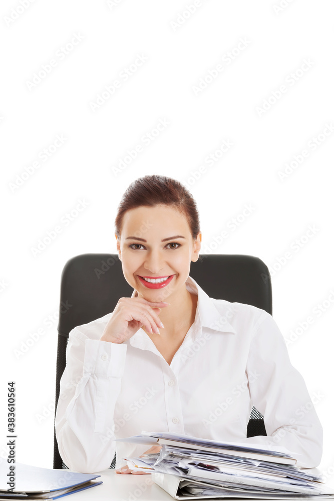 Beautiful business woman sitting by a desk.