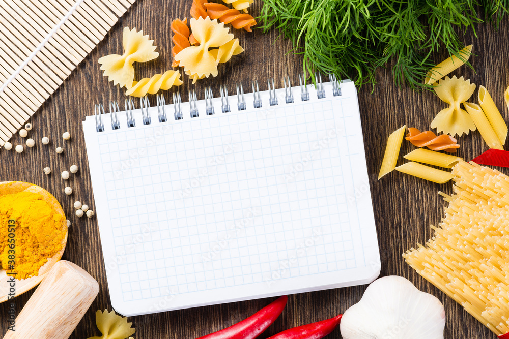 spices and vegetables around notebook