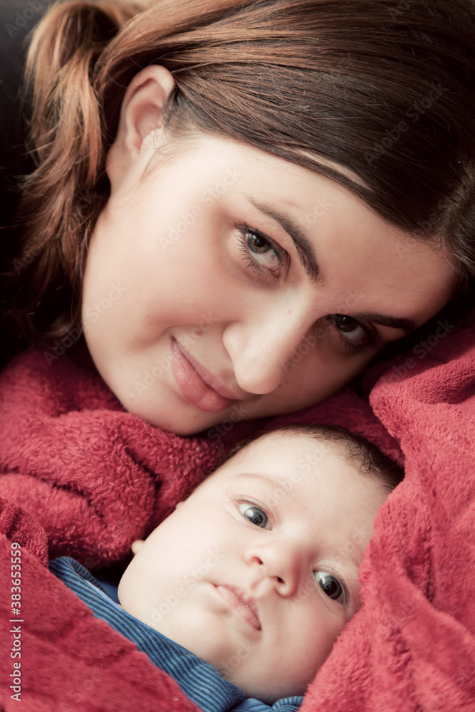 Mother with her young baby cuddling portrait