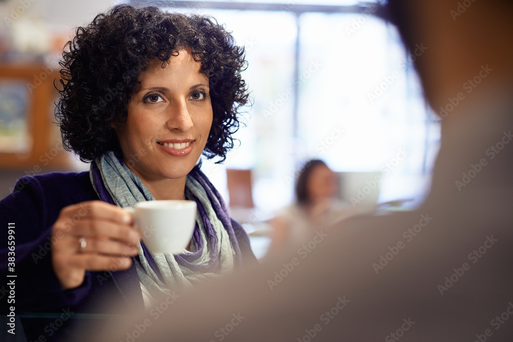 People in bar with woman drinking espresso coffee