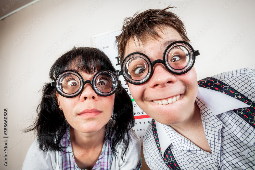 Two person wearing spectacles in an office at the doctor