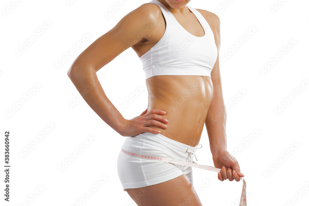 young athletic woman measuring waist