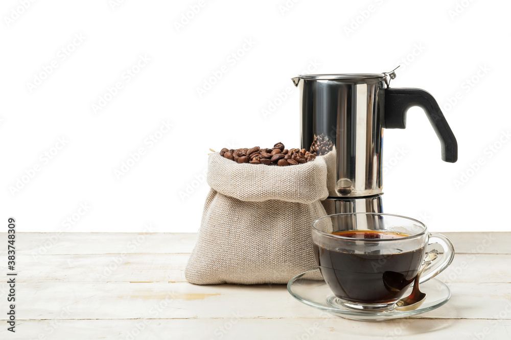 Composition with coffee and beans on table against white background