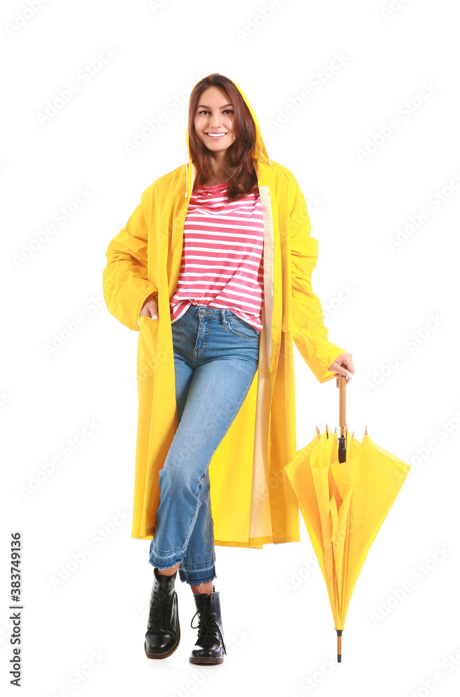 Beautiful young woman in raincoat and with umbrella on white background