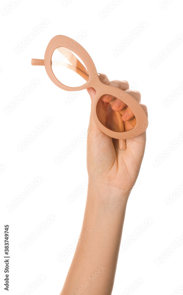 Female hand with stylish eyeglasses on white background