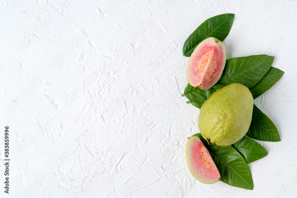 Top view of beautiful red guava with fresh green leaves.