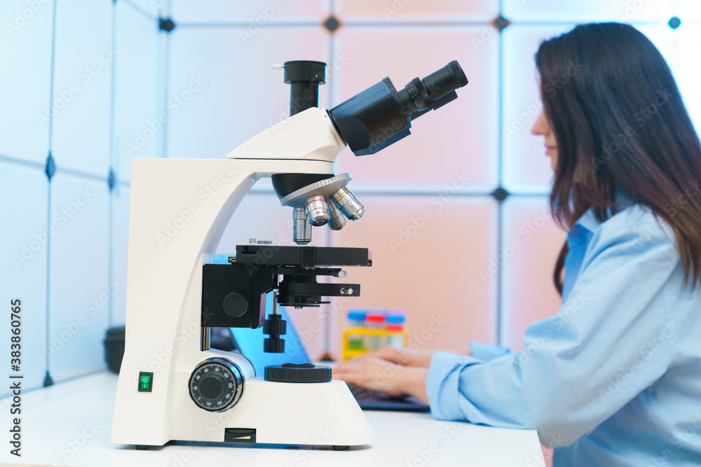 Young woman in a science lab. Health care researchers working in life science laboratory.