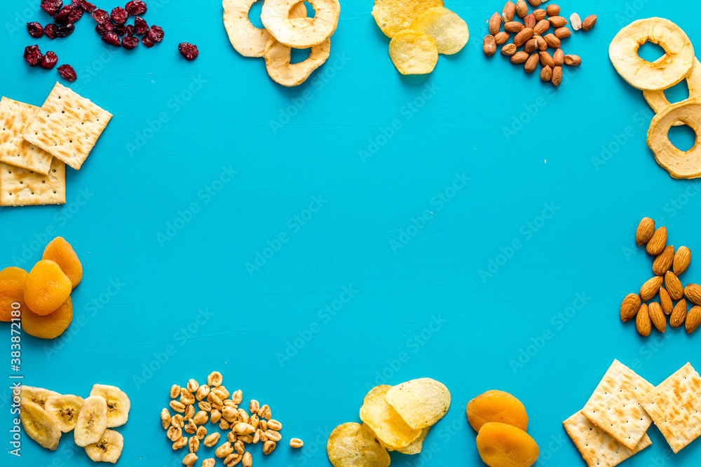 Frame of nuts overhead with dried fruits and other snacks top view