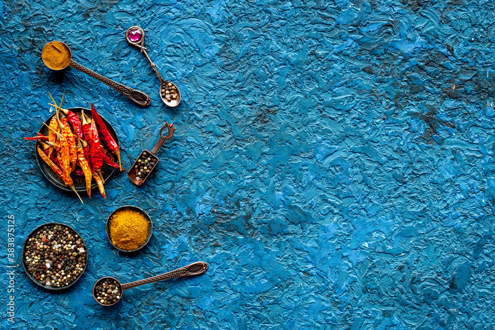 Hot spices and aromatic herbswith cooking utensils overhead