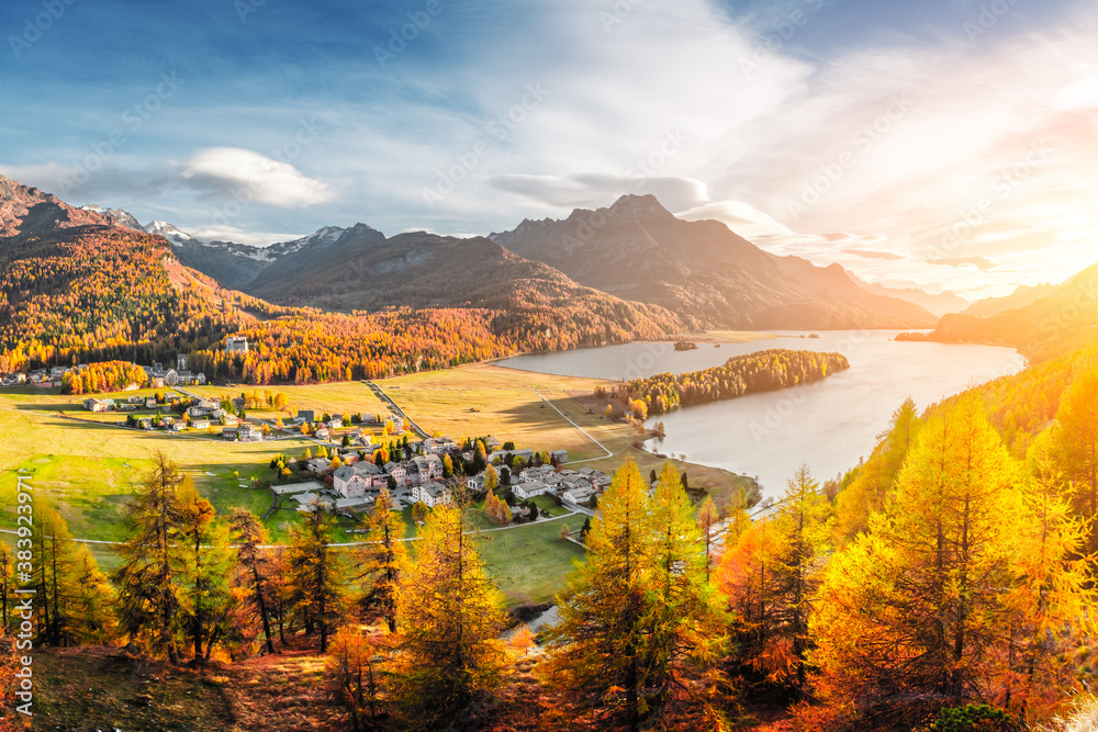 Panorama of Sils village and lake Sils (Silsersee) in Swiss Alps mountains. Colorful forest with ora