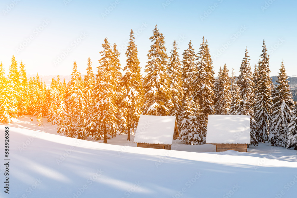 Fantastic winter landscape with wooden house in snowy mountains. Christmas holiday concept