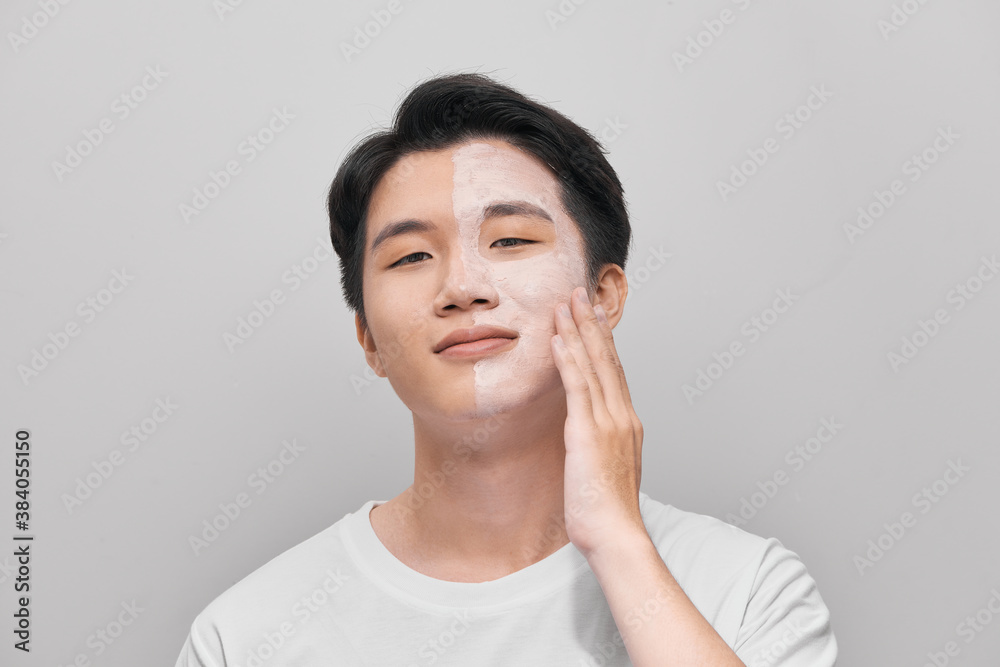 young man has mud clay mask on face