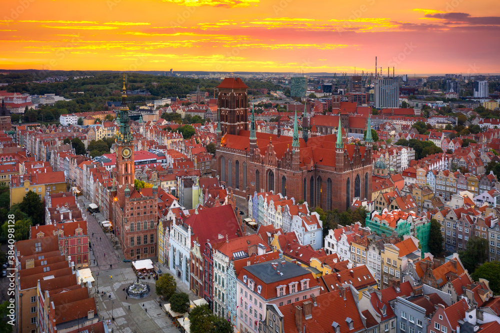 Beautiful sunset over the old town of Gdansk with City Hall and St. Mary Basilica, Poland