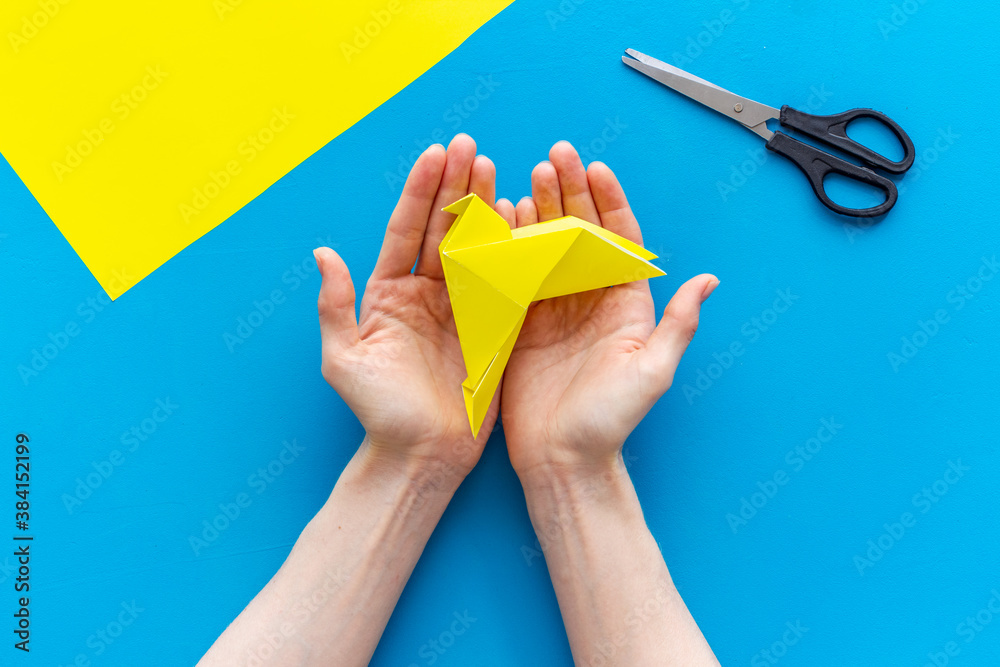 DIY concept. Doing origami paper bird, Top view