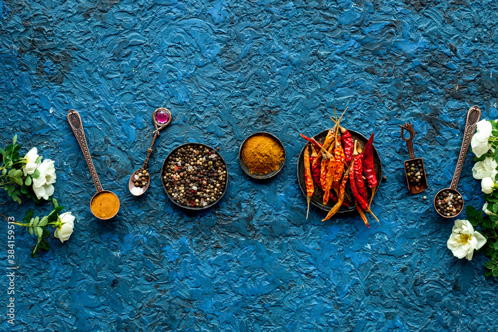 Hot spices and aromatic herbswith cooking utensils overhead