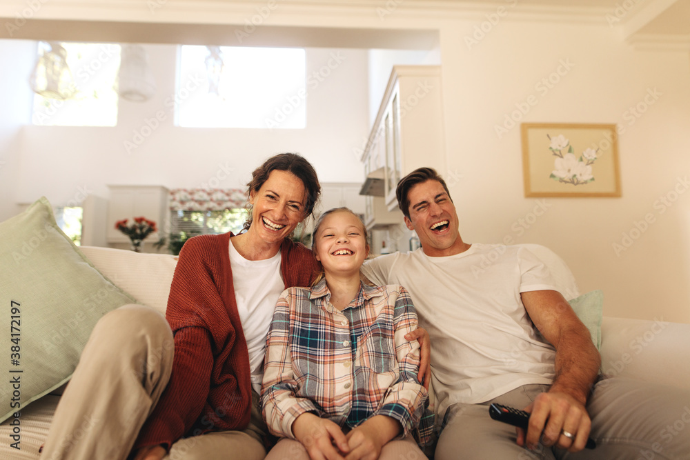 Family relaxing at home watching tv